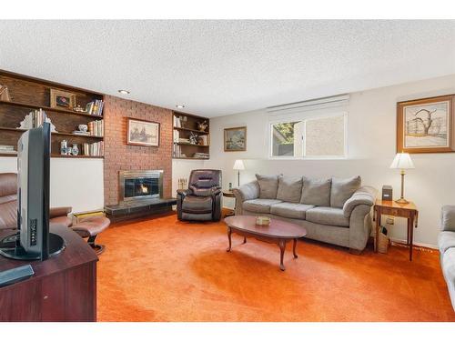 143 Brookgreen Drive Sw, Calgary, AB - Indoor Photo Showing Living Room With Fireplace