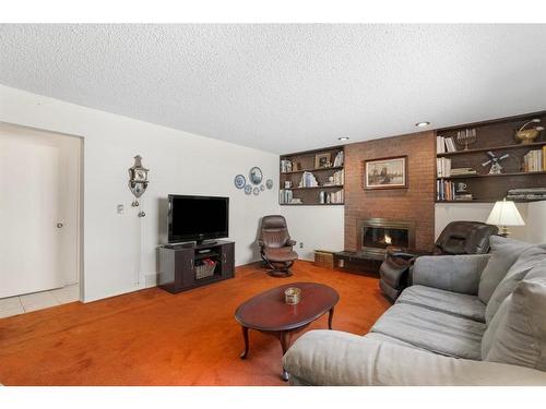 143 Brookgreen Drive Sw, Calgary, AB - Indoor Photo Showing Living Room With Fireplace