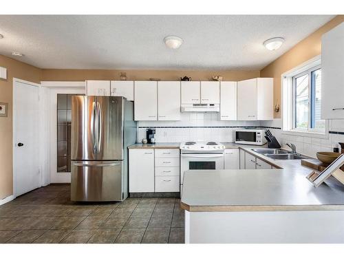 30 River Rock Way Se, Calgary, AB - Indoor Photo Showing Kitchen With Double Sink