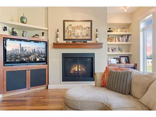 404-8 Hemlock Crescent Sw, Calgary, AB - Indoor Photo Showing Living Room With Fireplace