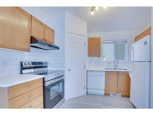 83 Saddlemont Manor Ne, Calgary, AB - Indoor Photo Showing Kitchen With Double Sink