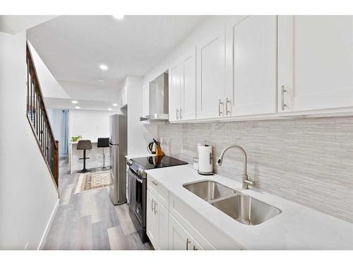 25 Carringham Heights Nw, Calgary, AB - Indoor Photo Showing Kitchen With Double Sink With Upgraded Kitchen