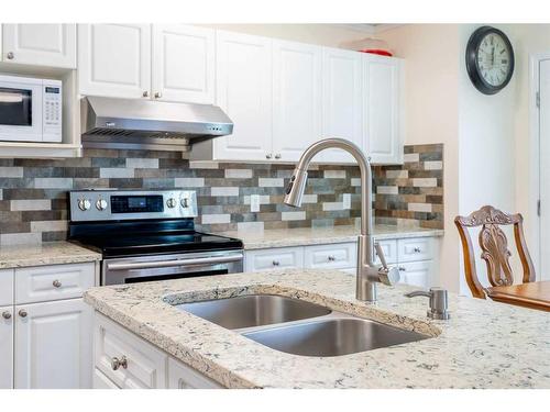 123 Chapalina Crescent Se, Calgary, AB - Indoor Photo Showing Kitchen With Double Sink