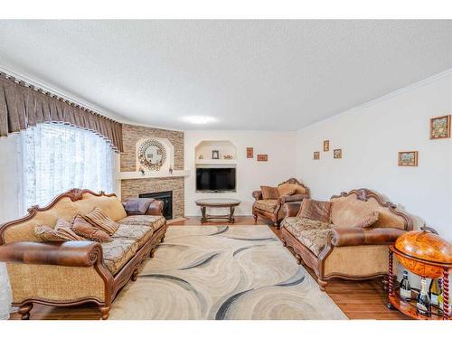 123 Chapalina Crescent Se, Calgary, AB - Indoor Photo Showing Living Room With Fireplace