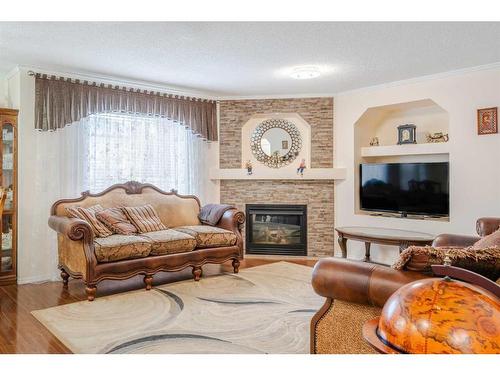 123 Chapalina Crescent Se, Calgary, AB - Indoor Photo Showing Living Room With Fireplace