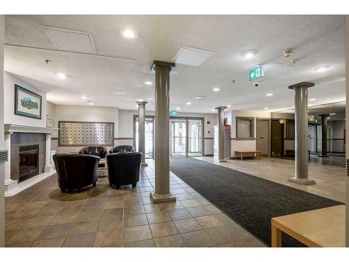 220-525 56 Avenue Sw, Calgary, AB - Indoor Photo Showing Other Room With Fireplace