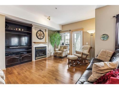 281-223 Tuscany Springs Boulevard Nw, Calgary, AB - Indoor Photo Showing Living Room With Fireplace