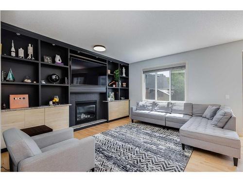 207 Cooperstown Lane Sw, Airdrie, AB - Indoor Photo Showing Living Room With Fireplace