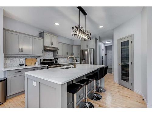 207 Cooperstown Lane Sw, Airdrie, AB - Indoor Photo Showing Kitchen With Double Sink