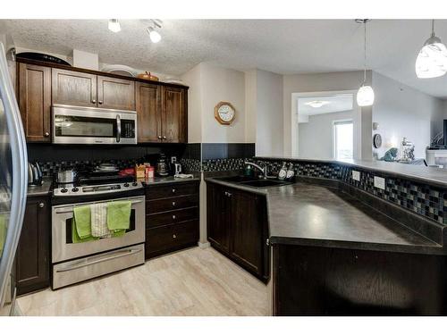 1429-8810 Royal Birch Boulevard Nw, Calgary, AB - Indoor Photo Showing Kitchen With Double Sink