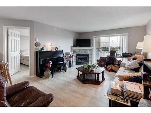 1429-8810 Royal Birch Boulevard Nw, Calgary, AB - Indoor Photo Showing Living Room With Fireplace