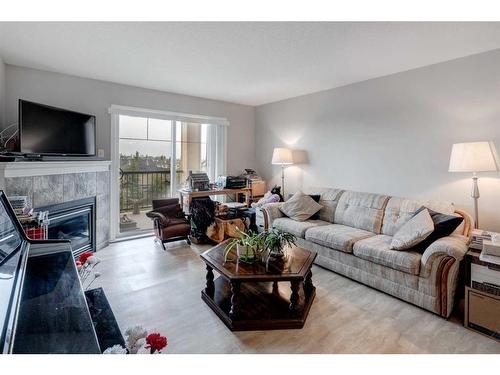 1429-8810 Royal Birch Boulevard Nw, Calgary, AB - Indoor Photo Showing Living Room With Fireplace