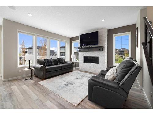 95 Silverado Crest Place Sw, Calgary, AB - Indoor Photo Showing Living Room With Fireplace