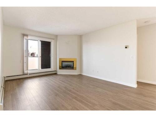 31-1131 Edenwold Heights Nw, Calgary, AB - Indoor Photo Showing Living Room With Fireplace