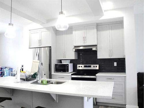 844 Lawthorn Way Se, Airdrie, AB - Indoor Photo Showing Kitchen With Double Sink With Upgraded Kitchen