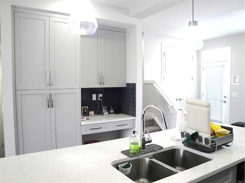 844 Lawthorn Way Se, Airdrie, AB - Indoor Photo Showing Kitchen With Double Sink