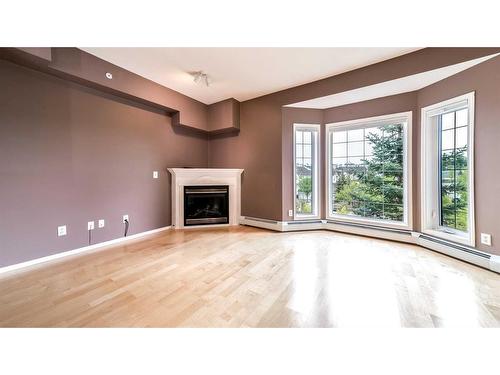 387-223 Tuscany Springs Boulevard Nw, Calgary, AB - Indoor Photo Showing Living Room With Fireplace