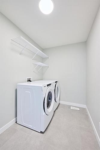 48 Shawnee Green Sw, Calgary, AB - Indoor Photo Showing Laundry Room