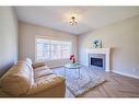 48 Shawnee Green Sw, Calgary, AB  - Indoor Photo Showing Living Room With Fireplace 