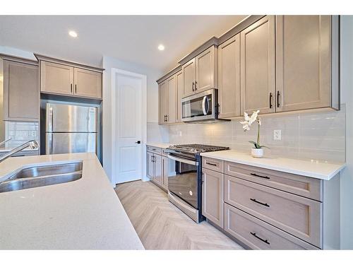 48 Shawnee Green Sw, Calgary, AB - Indoor Photo Showing Kitchen With Stainless Steel Kitchen With Double Sink With Upgraded Kitchen