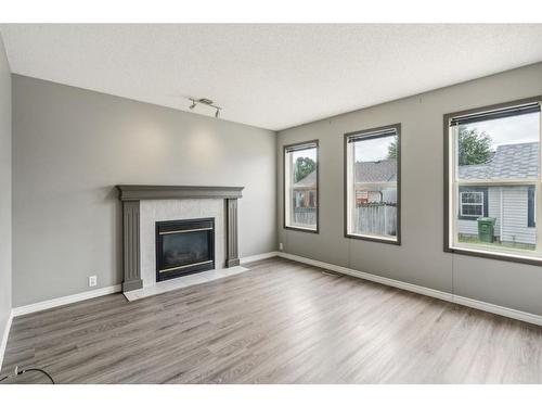 1141 Prestwick Circle Se, Calgary, AB - Indoor Photo Showing Living Room With Fireplace