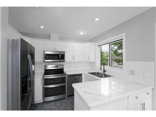 195 Sandstone Drive, Okotoks, AB - Indoor Photo Showing Kitchen With Double Sink