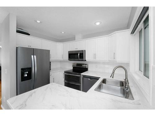 195 Sandstone Drive, Okotoks, AB - Indoor Photo Showing Kitchen With Double Sink