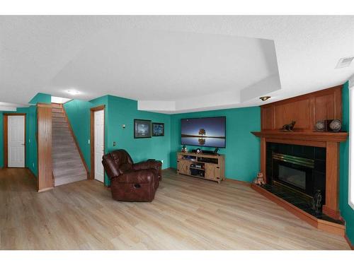 195 Sandstone Drive, Okotoks, AB - Indoor Photo Showing Living Room With Fireplace