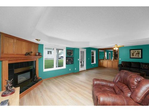 195 Sandstone Drive, Okotoks, AB - Indoor Photo Showing Living Room With Fireplace