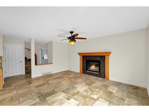 164 Bridlepost Green Sw, Calgary, AB - Indoor Photo Showing Living Room With Fireplace