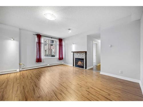 104-990 Centre Avenue Ne, Calgary, AB - Indoor Photo Showing Living Room With Fireplace