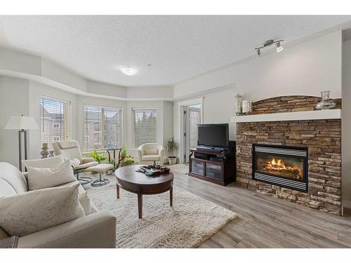 428-30 Discovery Ridge Close Sw, Calgary, AB - Indoor Photo Showing Living Room With Fireplace