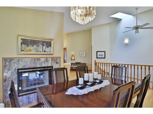 247 Hamptons Park Nw, Calgary, AB - Indoor Photo Showing Dining Room With Fireplace