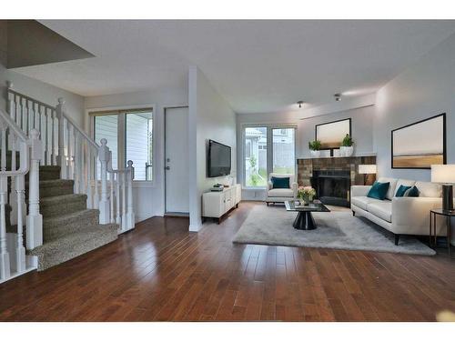 205 Coachway Lane Sw, Calgary, AB - Indoor Photo Showing Living Room With Fireplace