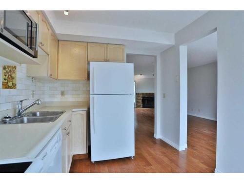205 Coachway Lane Sw, Calgary, AB - Indoor Photo Showing Kitchen With Double Sink