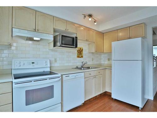 205 Coachway Lane Sw, Calgary, AB - Indoor Photo Showing Kitchen With Double Sink