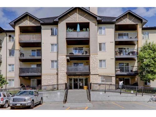 8423-304 Mackenzie Way Sw, Airdrie, AB - Outdoor With Balcony With Facade