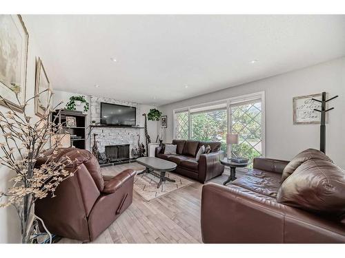 7927 Huntwick Hill Ne, Calgary, AB - Indoor Photo Showing Living Room With Fireplace