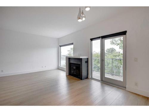 202-2124 17 Street Sw, Calgary, AB - Indoor Photo Showing Living Room With Fireplace