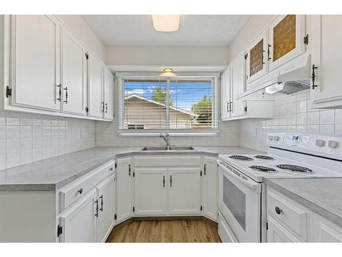 452 Queen Alexandra Way Se, Calgary, AB - Indoor Photo Showing Kitchen With Double Sink