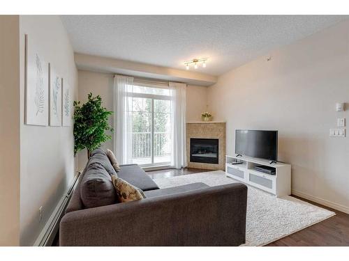 403-102 Cranberry Park Se, Calgary, AB - Indoor Photo Showing Living Room With Fireplace