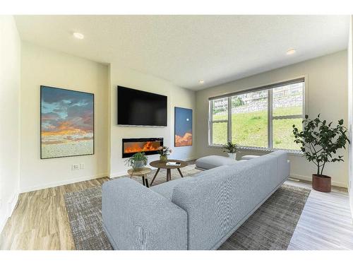 67 Arbour Lake Heights Nw, Calgary, AB - Indoor Photo Showing Living Room With Fireplace