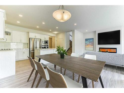 67 Arbour Lake Heights Nw, Calgary, AB - Indoor Photo Showing Dining Room With Fireplace