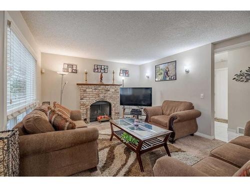 104 Riverglen Drive Se, Calgary, AB - Indoor Photo Showing Living Room With Fireplace