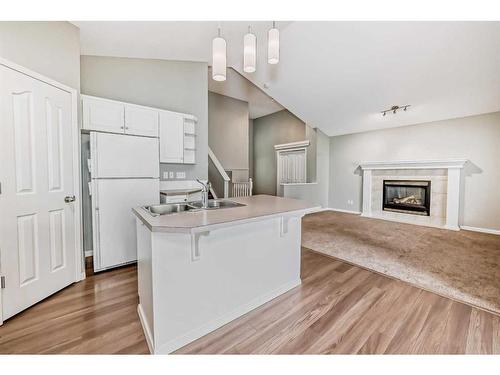 57 Inverness Rise Se, Calgary, AB - Indoor Photo Showing Kitchen With Fireplace With Double Sink