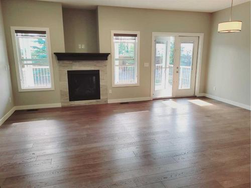 26 Stone Garden Crescent, Carstairs, AB - Indoor Photo Showing Living Room With Fireplace