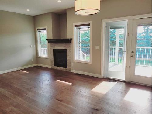 26 Stone Garden Crescent, Carstairs, AB - Indoor Photo Showing Living Room With Fireplace