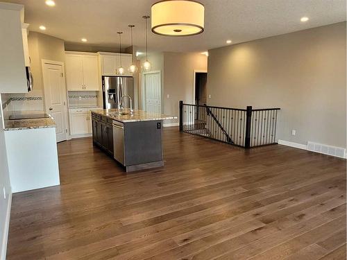 26 Stone Garden Crescent, Carstairs, AB - Indoor Photo Showing Kitchen With Double Sink