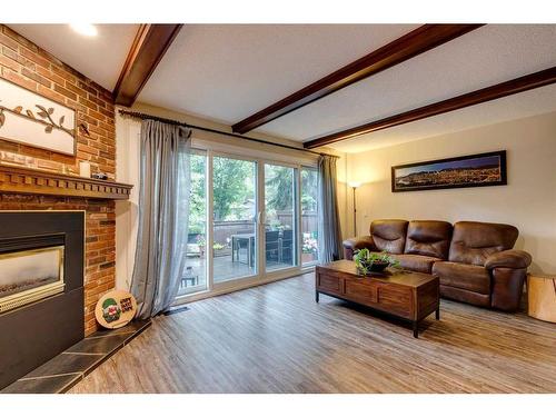 11-10910 Bonaventure Drive Se, Calgary, AB - Indoor Photo Showing Living Room With Fireplace