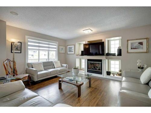 105 Everridge Drive Sw, Calgary, AB - Indoor Photo Showing Living Room With Fireplace